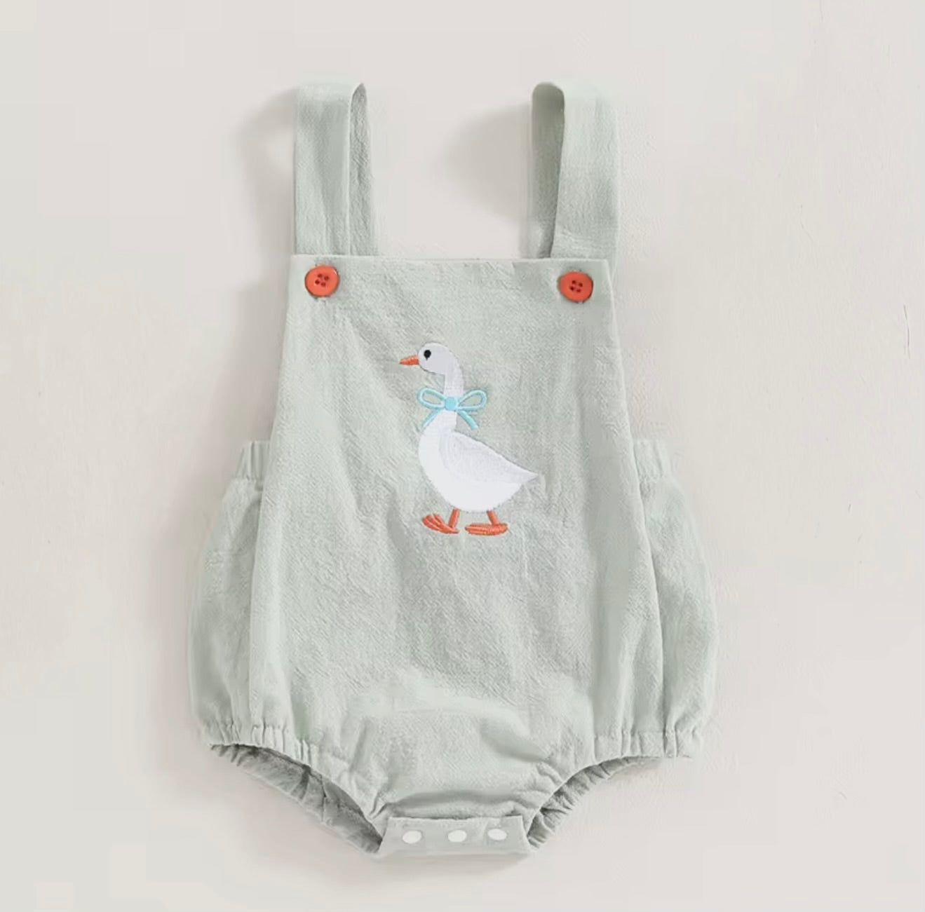 Light blue baby romper with duck design on a white background
