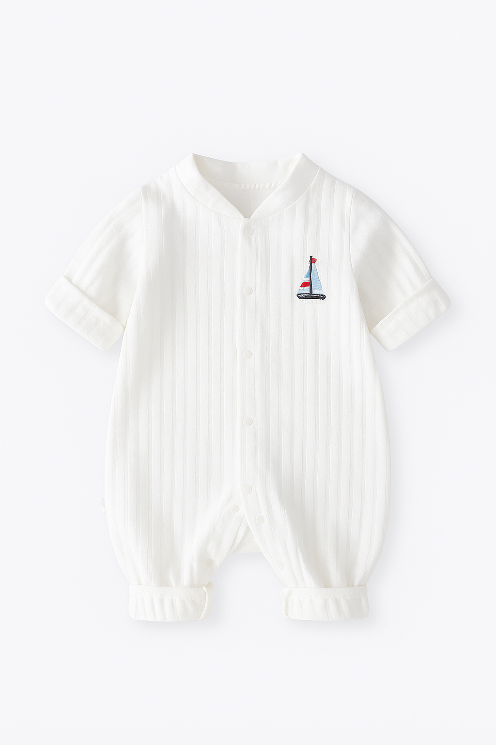 White ribbed onesie with a small embroidered sailboat design for boy and girl infants and baby clothing clothes on a white background