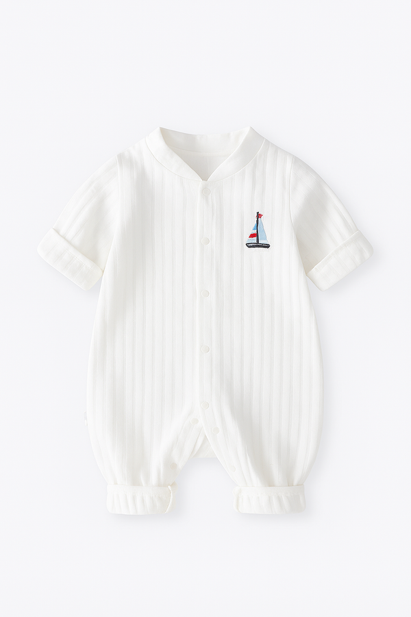 White ribbed onesie with a small embroidered sailboat design for boy and girl infants and baby clothing clothes on a white background